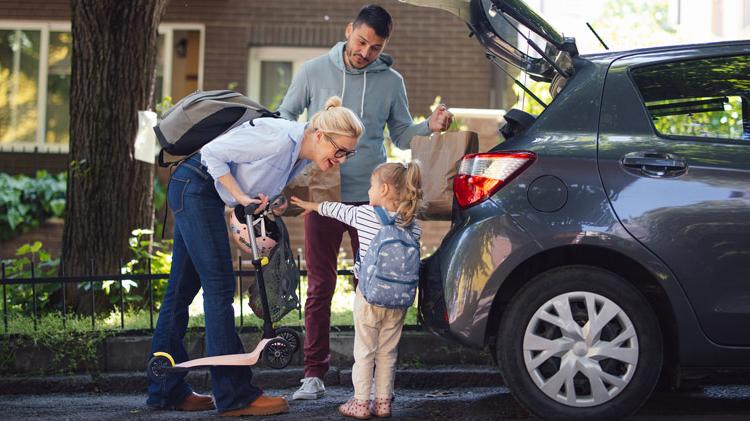 Family packing things in the car.